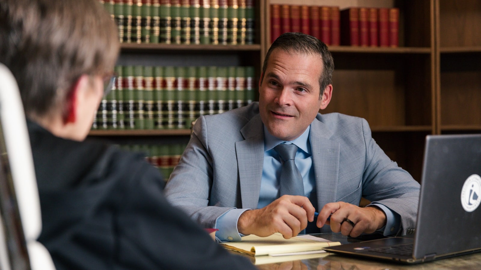 Emmanuel Miller meeting with a client in the law library at Precision Litigation Northwest