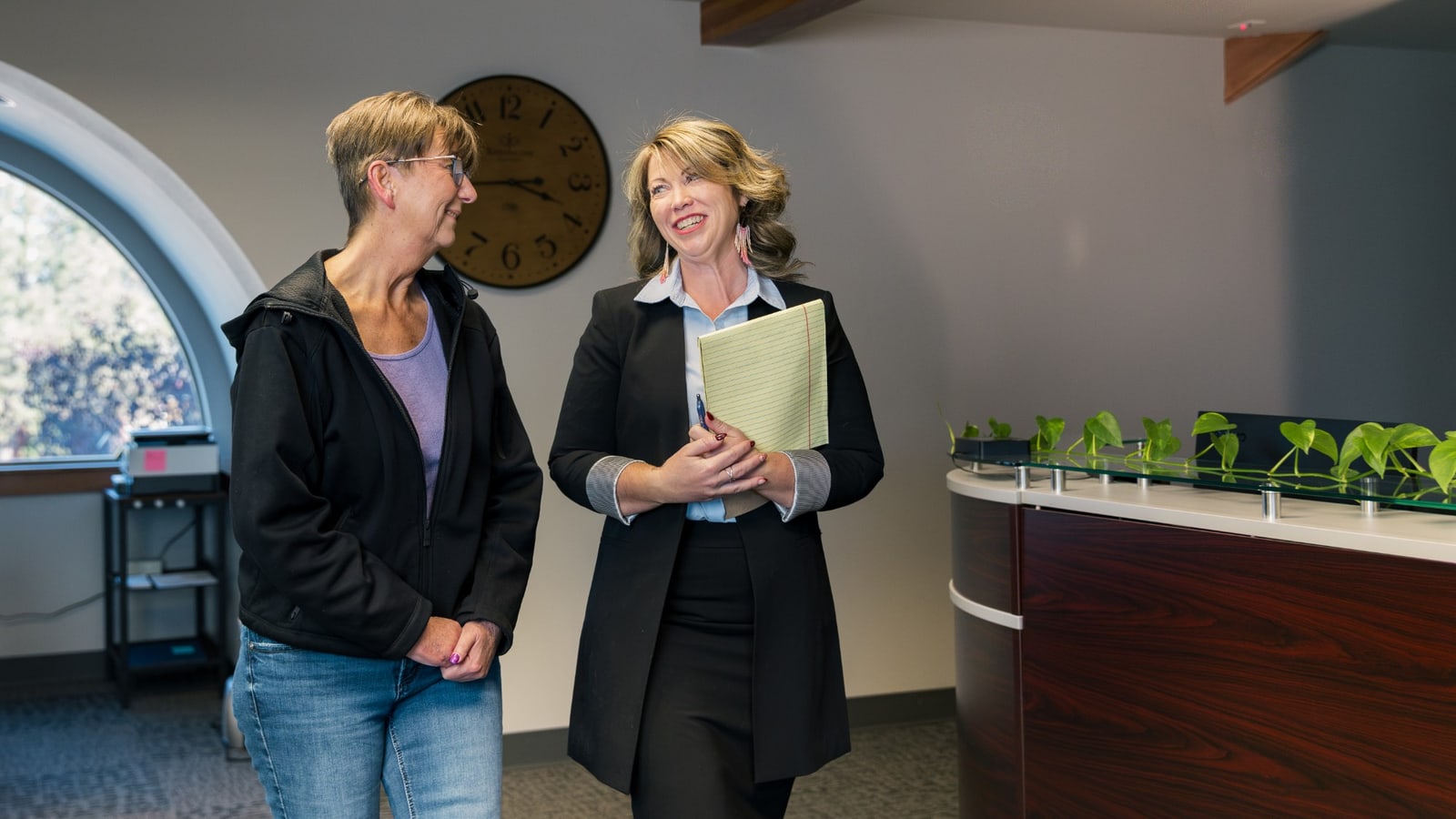 Jill Miller walking with a client through the Precision Litigation Northwest office