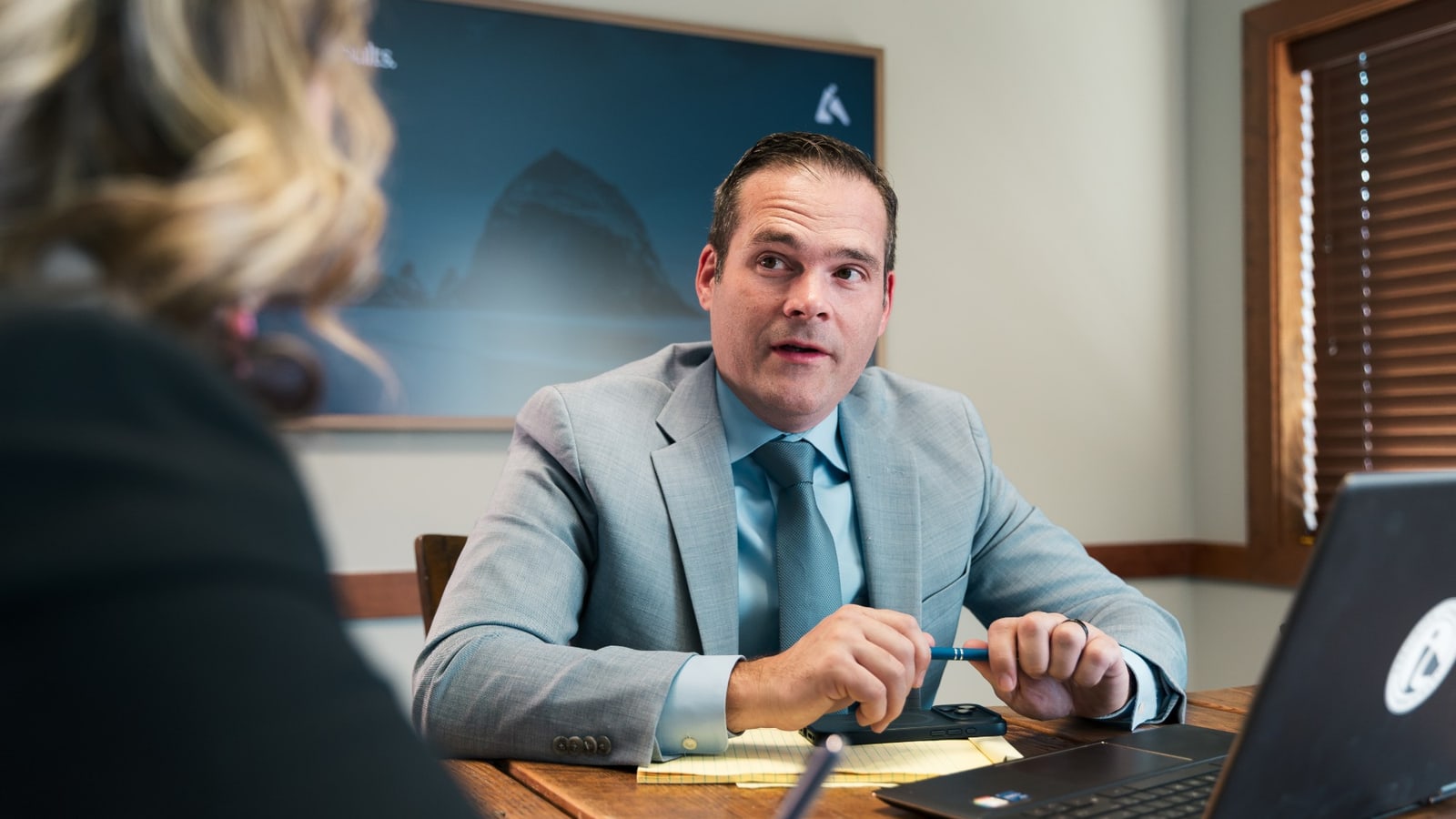 Emmanuel Miller talking a client through their case in the conference room at Precision Litigation Northwest